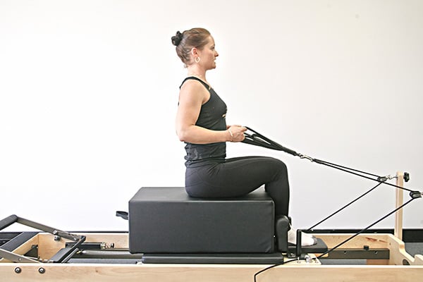 reformer exercise arms in straps